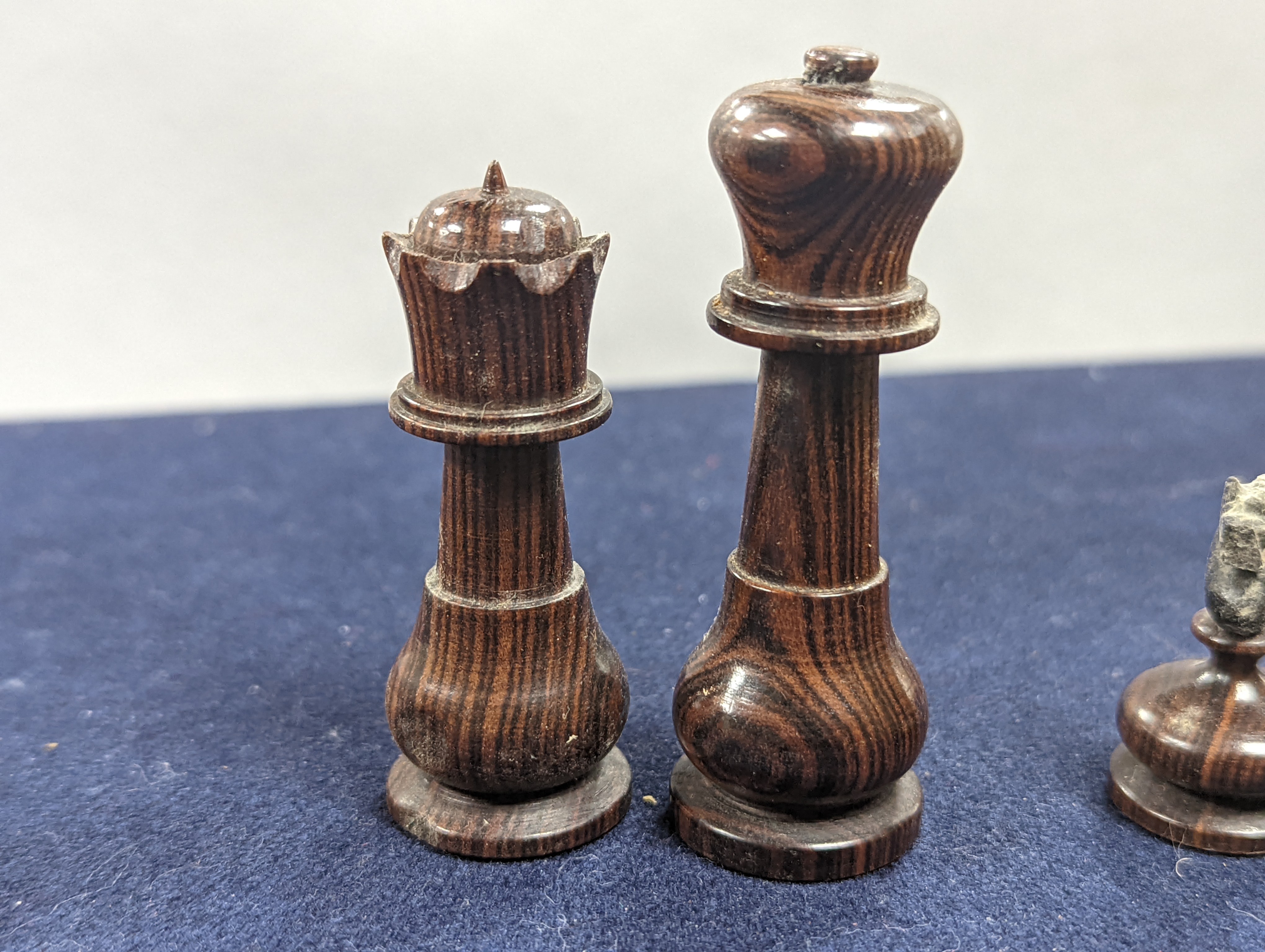 A Victorian brass inset mahogany games box, fitted with solitaire, cribbage, chessmen, draughts etc., 33cm, a turned and stained bone chess set, another games box containing chessmen and draughts